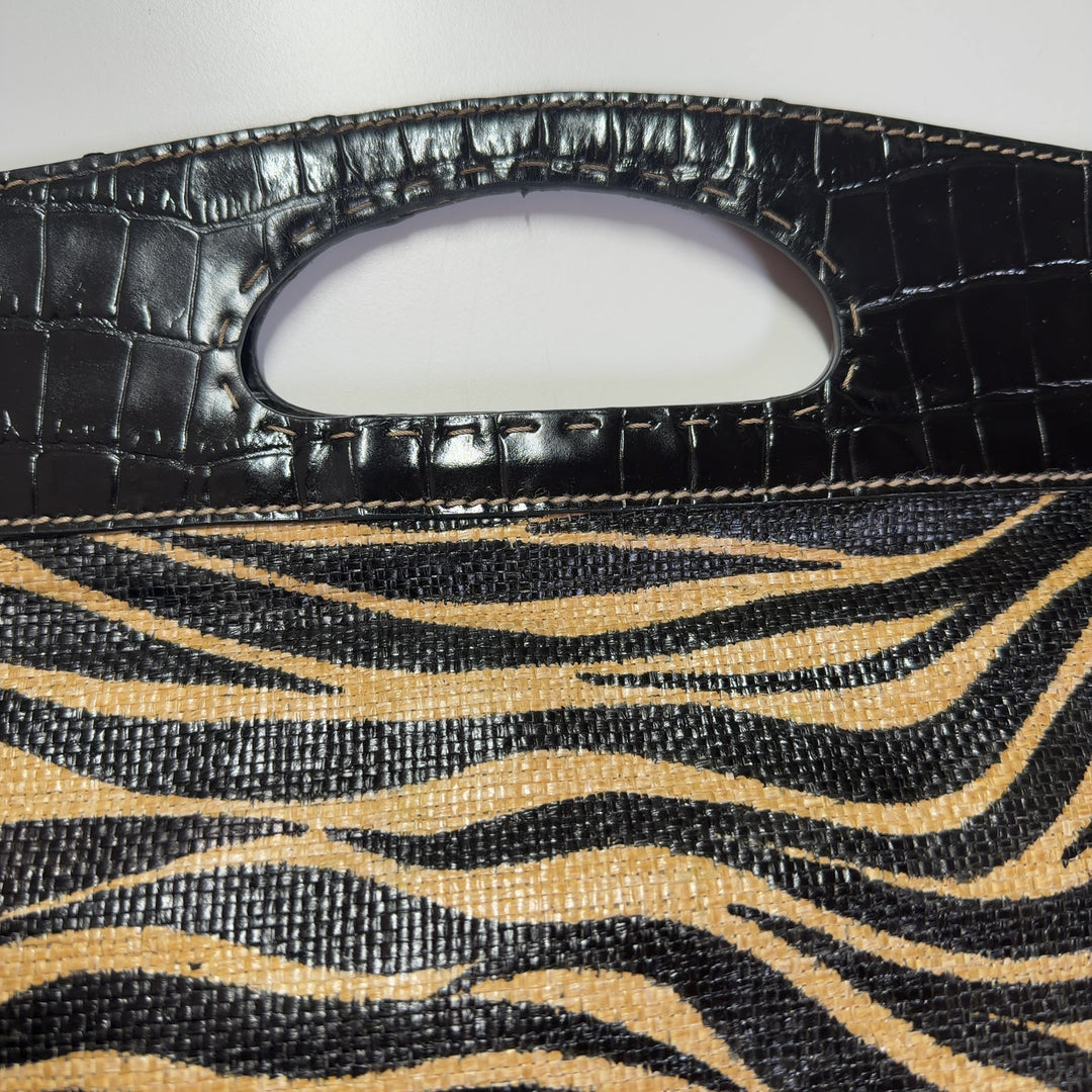 Black and gold zebra print Franco Sarto clutch with croc-embossed handle, back view styled with outfit