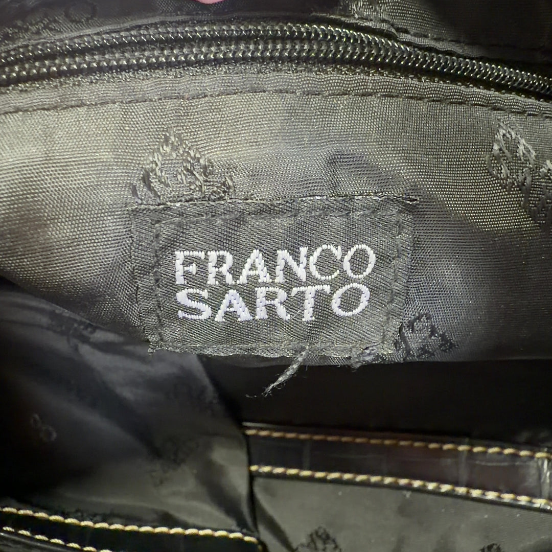 Black and gold zebra print Franco Sarto clutch with croc-embossed handle, back view styled with outfit