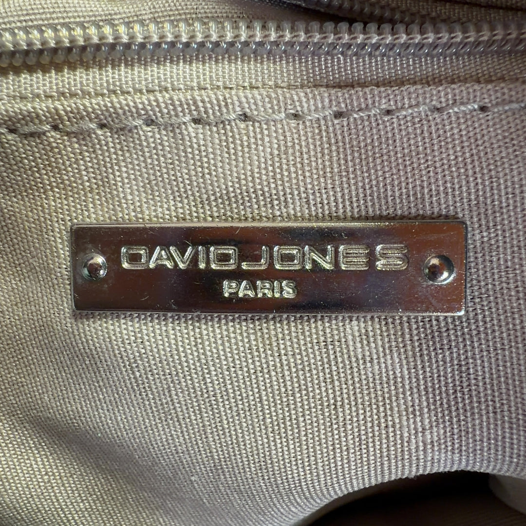 Tag view of sage green David Jones Paris crossbody bag worn on shoulder, showing structured silhouette and strap adjustment