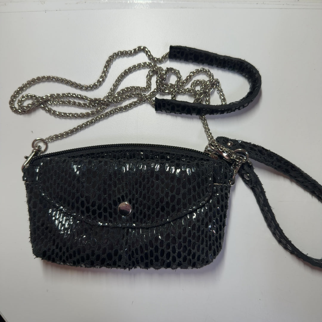 Black mesh crossbody bag XS worn as crossbody style on model, showing adjustable strap and compact size