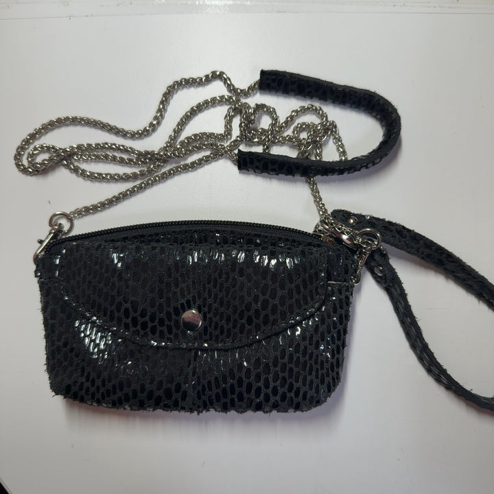 Black mesh crossbody bag XS worn as crossbody style on model, showing adjustable strap and compact size