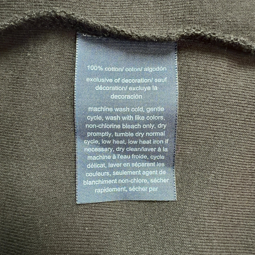 Black cotton polo shirt dress with white-tipped collar, back view showing A-line silhouette