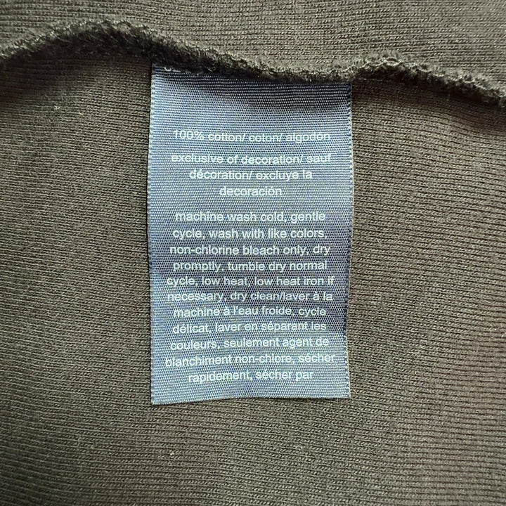 Black cotton polo shirt dress with white-tipped collar, back view showing A-line silhouette