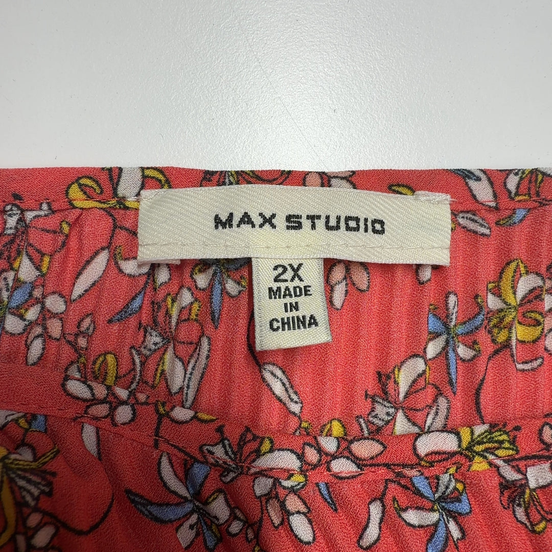 Red floral pleated cape top by Max Studio, back view displaying pleated detailing and decorative border trim