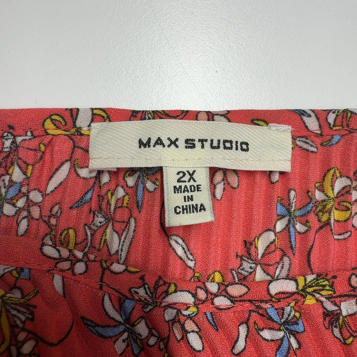 Red floral pleated cape top by Max Studio, back view displaying pleated detailing and decorative border trim