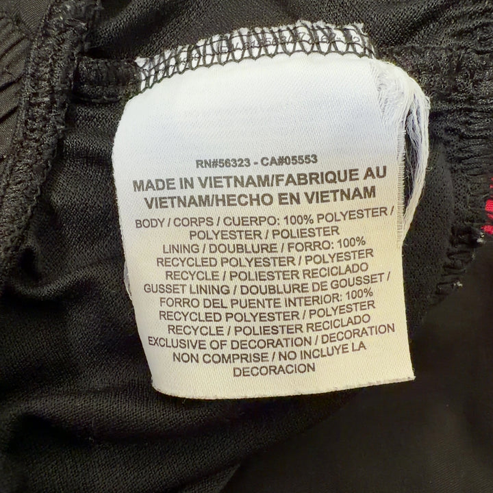 Black Nike athletic shorts with pink trim, back view displaying fit and athletic design