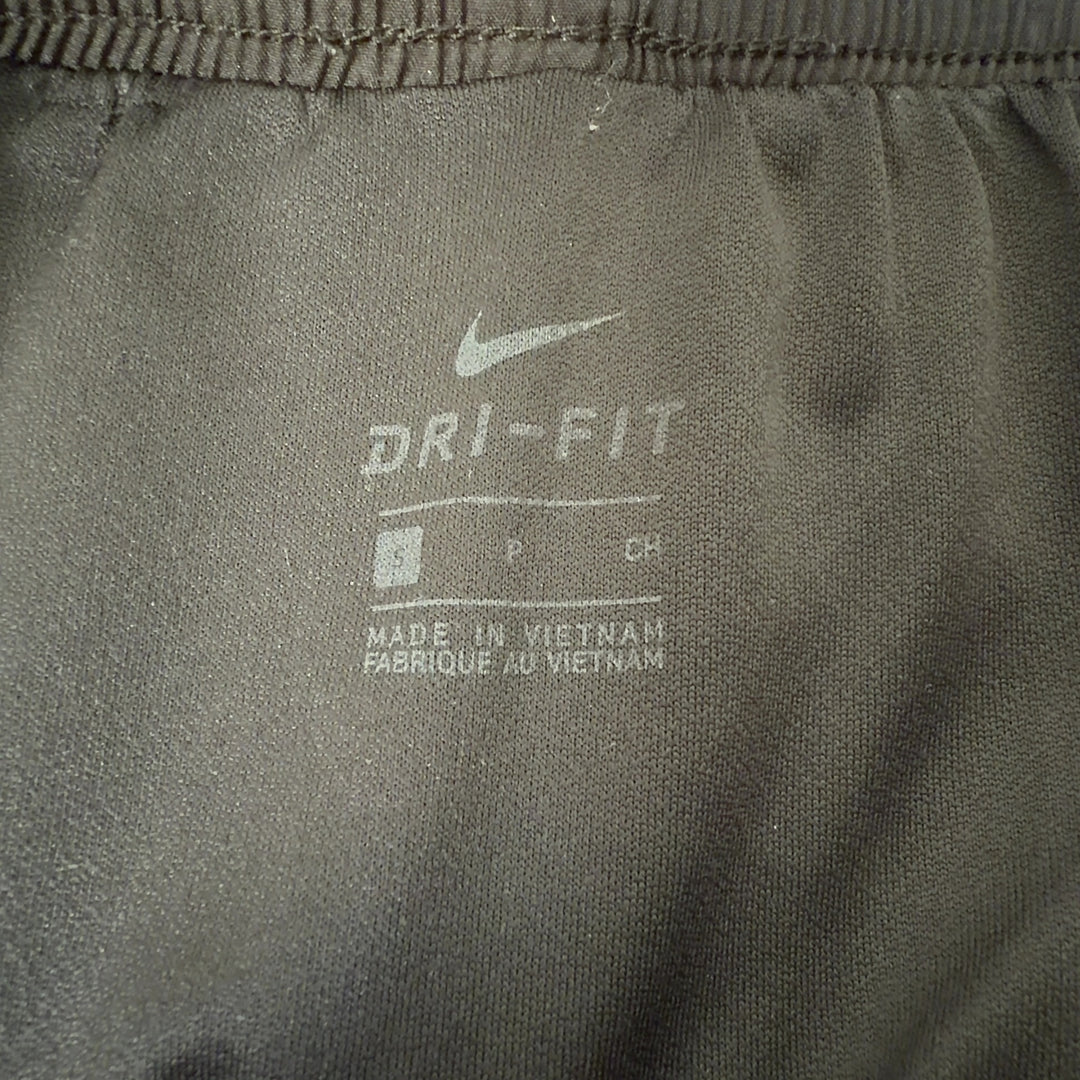 Black Nike athletic shorts with pink trim, back view displaying fit and athletic design