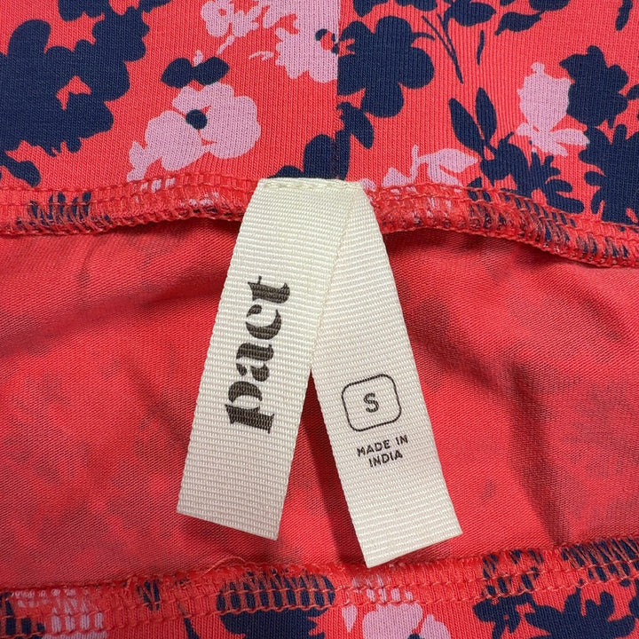 Red floral A-line midi skirt back view showing flattering silhouette and functional pockets