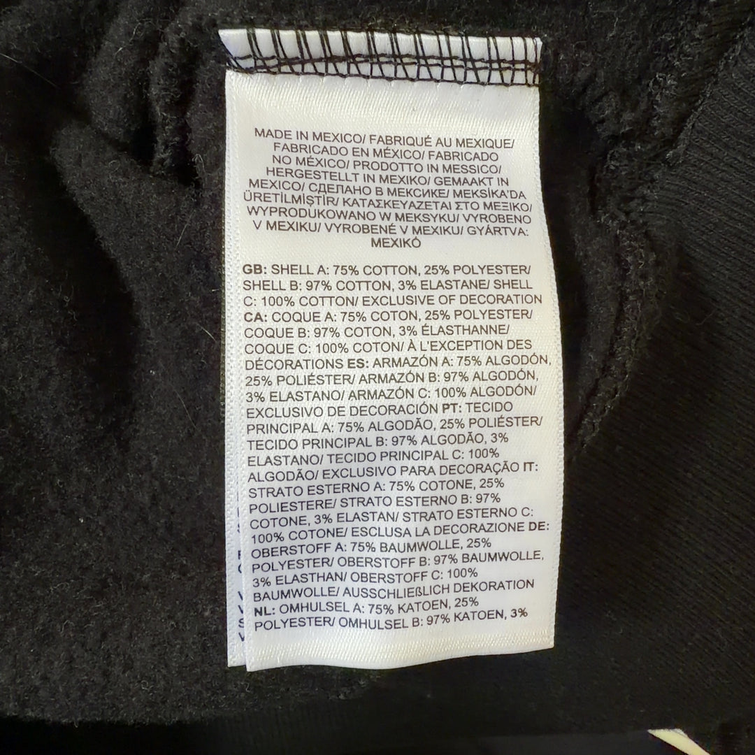 Tag view of black The North Face hoodie displaying logo placement and relaxed fit silhouette