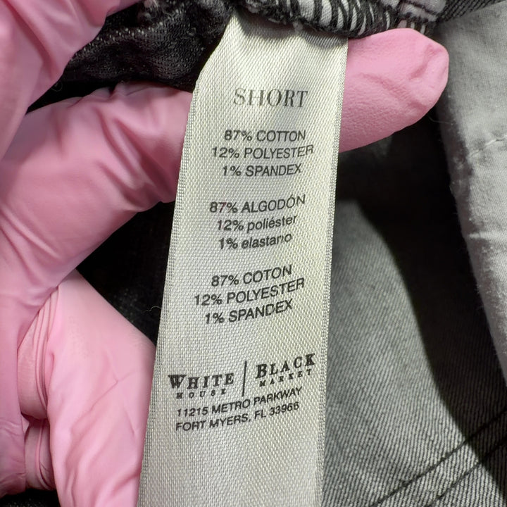 Tag view of charcoal denim shorts showing the fit and rolled cuff detail