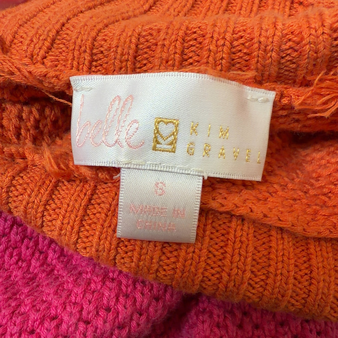 Tag view of orange colorblock knit pullover sweater showing horizontal stripe design and relaxed fit