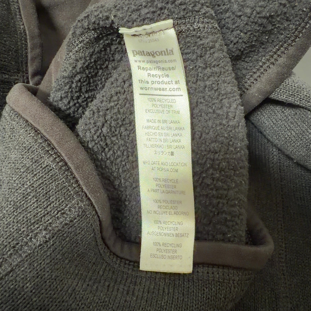 Patagonia black recycled polyester zip-up hoodie back view on model, showing fitted silhouette and side pockets