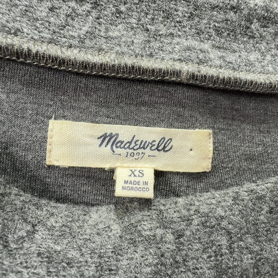 Tag view of gray wool-blend shift dress showing relaxed silhouette and side pocket detail