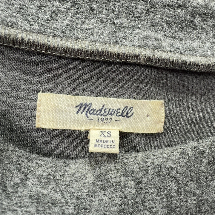 Tag view of gray wool-blend shift dress showing relaxed silhouette and side pocket detail