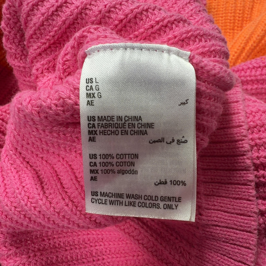 Orange and pink color block knit pullover back view showing horizontal color blocking design