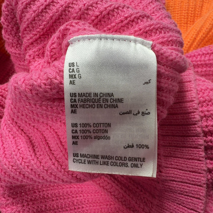 Orange and pink color block knit pullover back view showing horizontal color blocking design