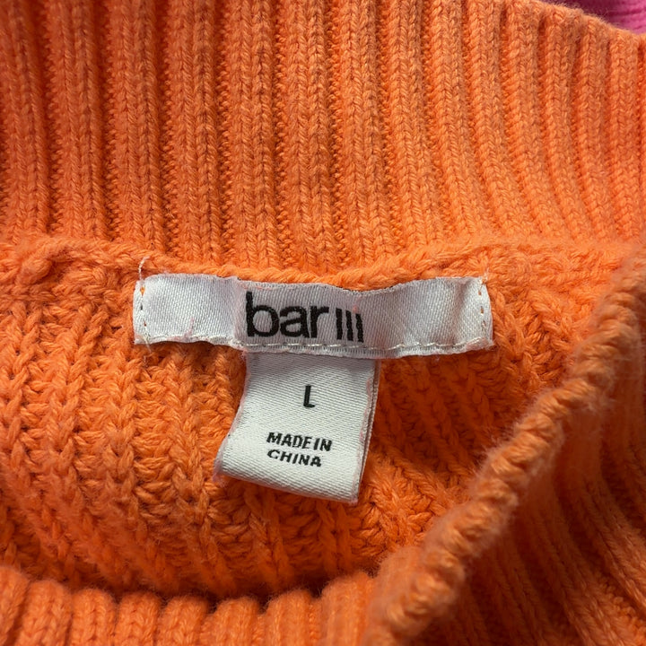 Orange and pink color block knit pullover back view showing horizontal color blocking design