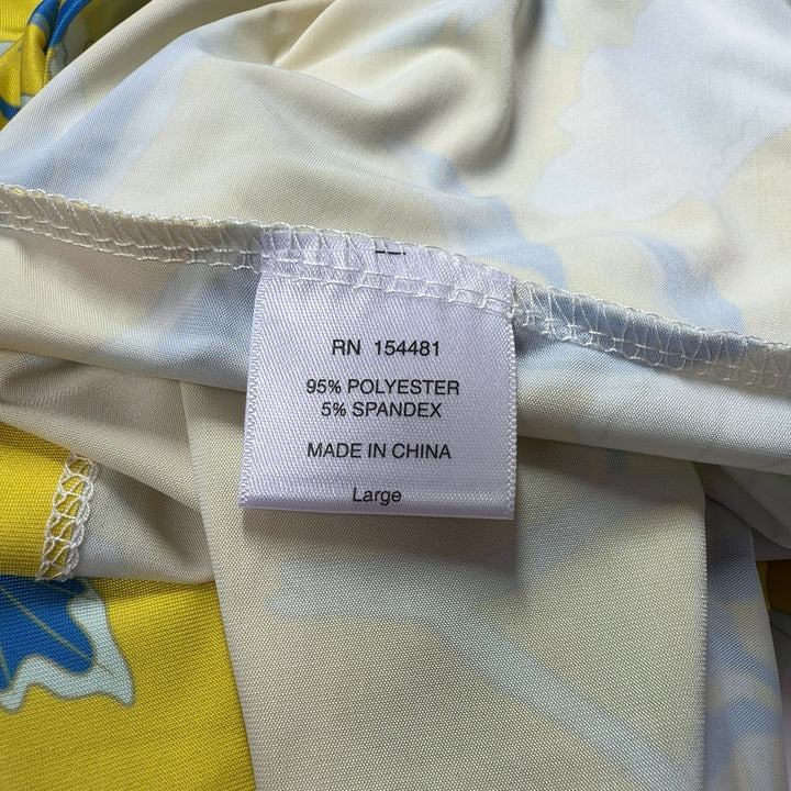 Tag view of yellow floral print shift dress showing the full botanical pattern and relaxed shift silhouette