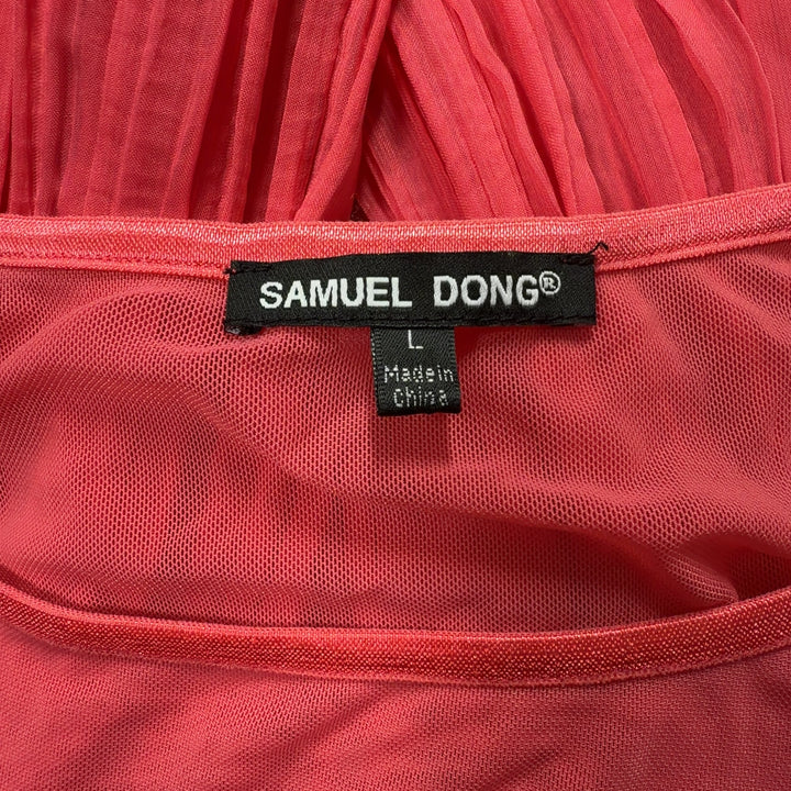 Tag view of red pleated long sleeve top showing pleated detailing and relaxed fit
