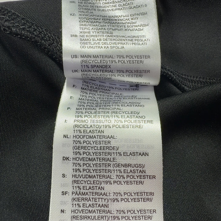 Adidas black colorblock leggings back view displaying Adidas branding on lower leg and colorblock paneling detail