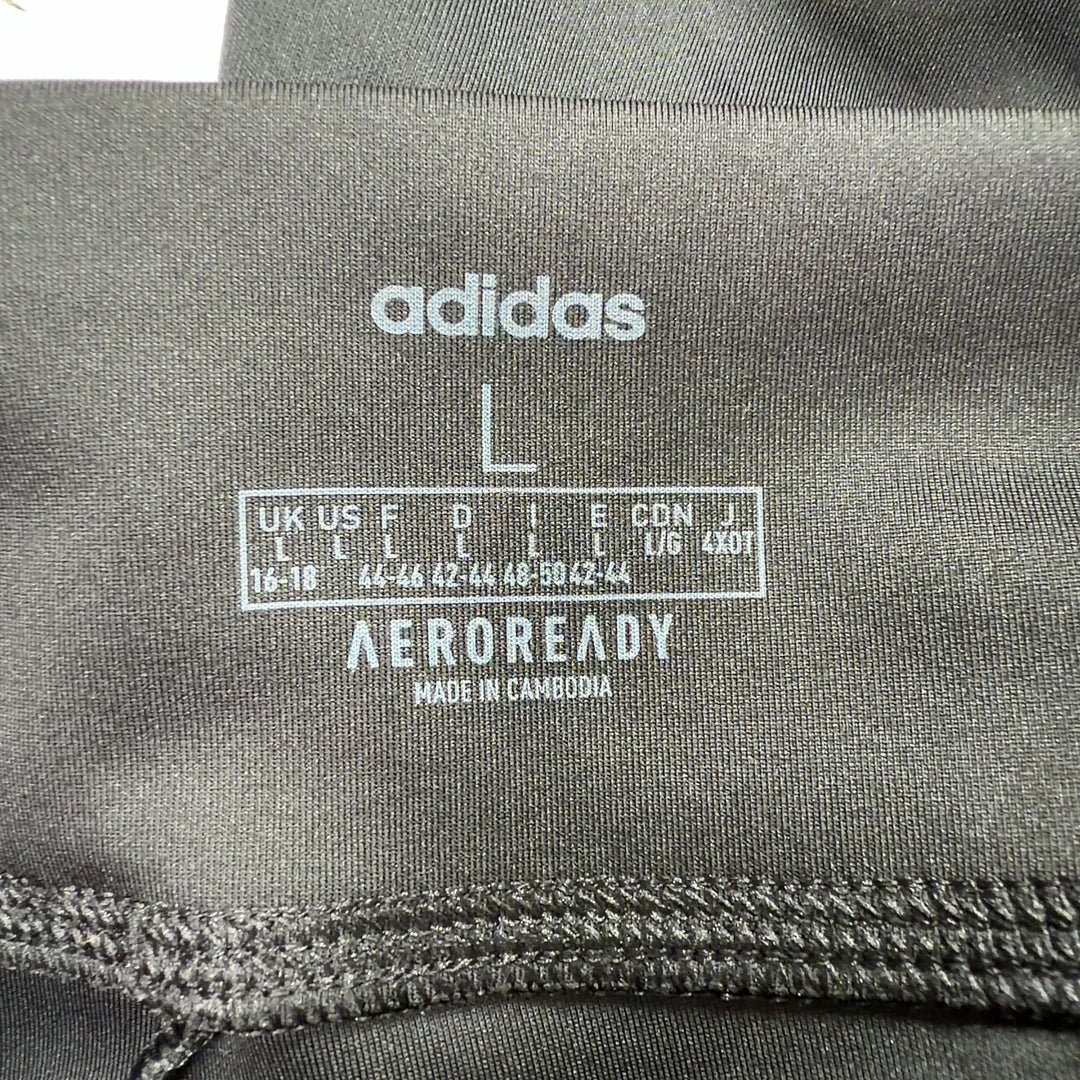 Adidas black colorblock leggings back view displaying Adidas branding on lower leg and colorblock paneling detail