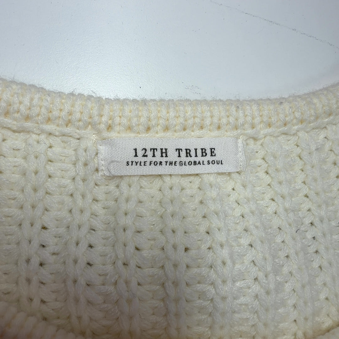 Tag view of cream ribbed knit sweater with fringe sleeves, showing relaxed fit and cropped silhouette