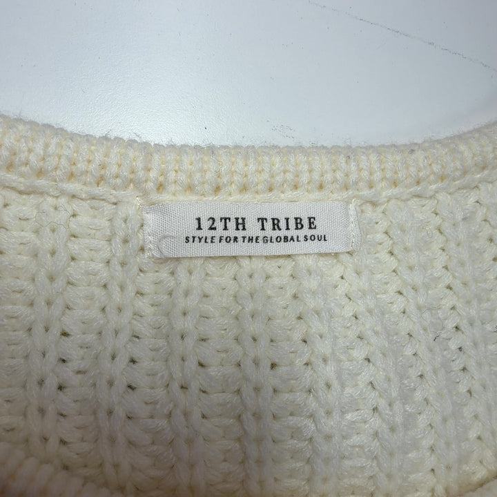 Tag view of cream ribbed knit sweater with fringe sleeves, showing relaxed fit and cropped silhouette