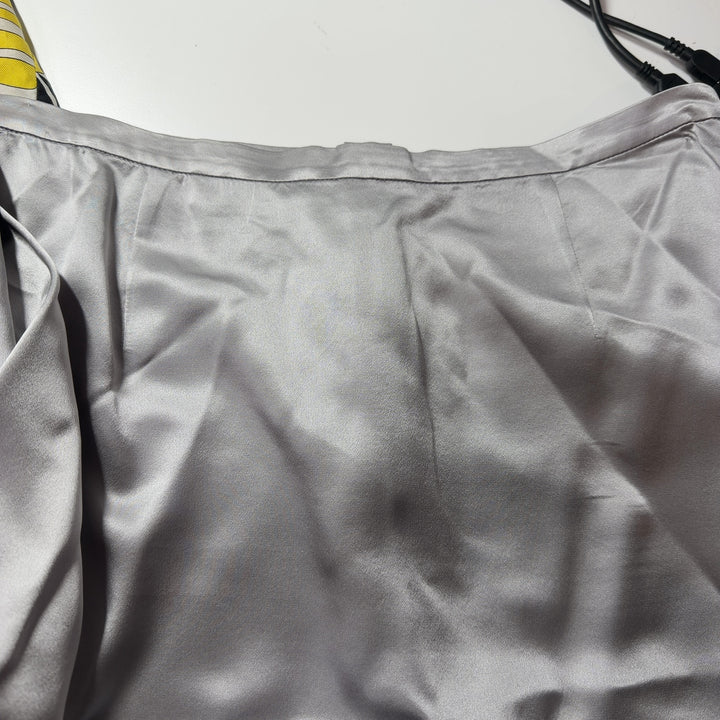Cream silk pencil skirt back view, displaying elegant drape and classic straight cut design