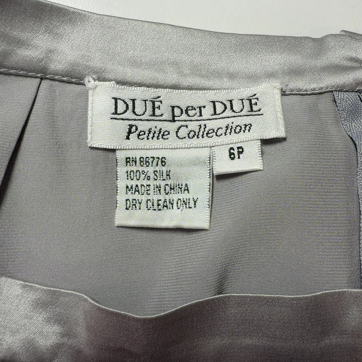 Cream silk pencil skirt back view, displaying elegant drape and classic straight cut design