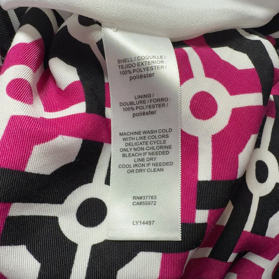 Tag view of pink geometric print shift dress showing relaxed shift silhouette and knee-length cut