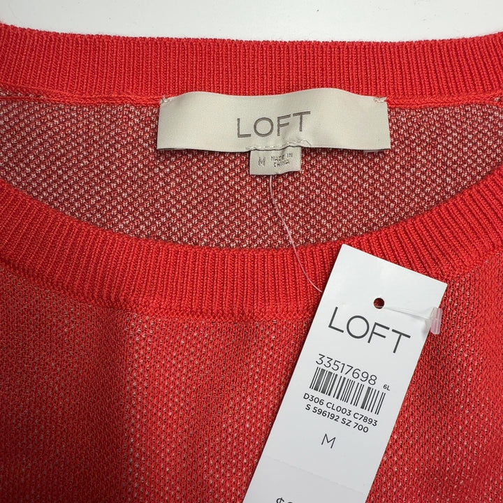 Tag view of red horse print knit sweater showing full animal print design