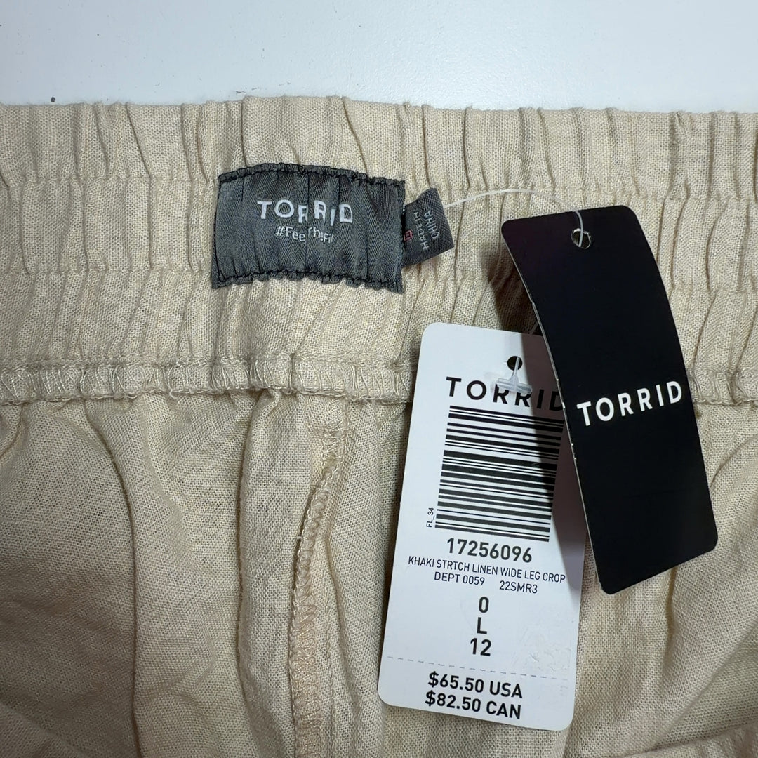 Tag view of cream linen wide-leg cropped pants showing relaxed fit and functional pockets