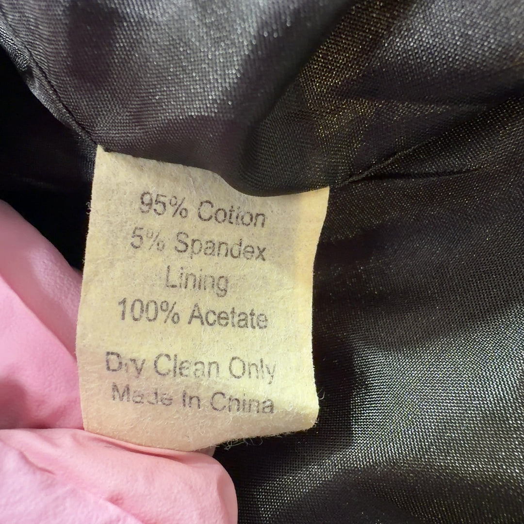 Tag view of green geometric patterned jacket by Skirtin Around showing the full length and drape of the tailored design