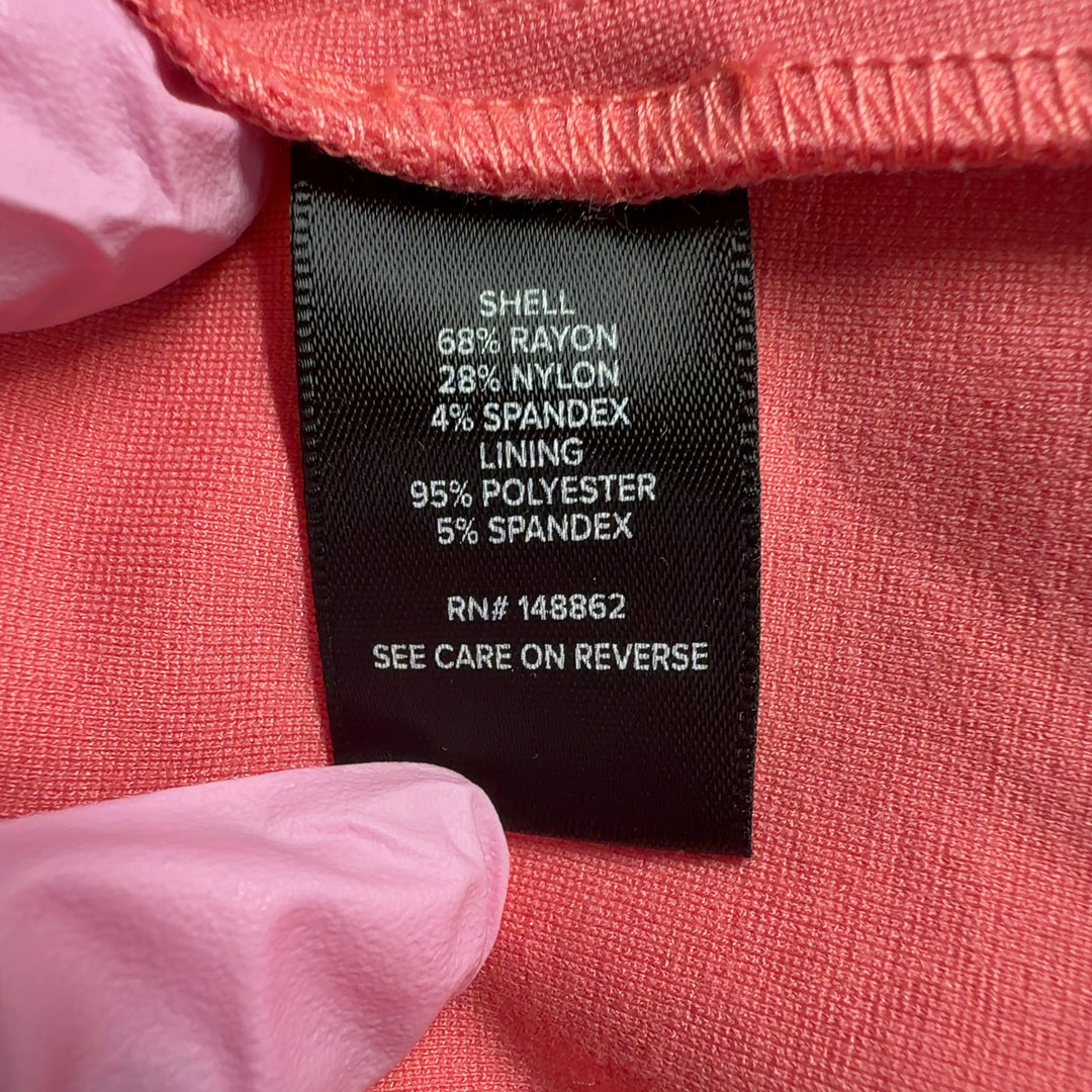 Tag view of pink blazer jacket showing tailored silhouette and cropped length