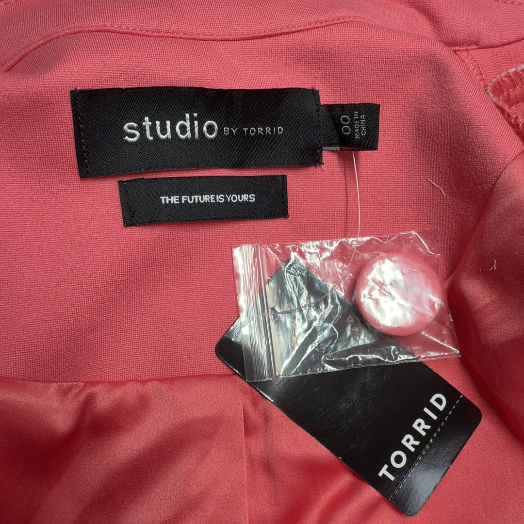 Tag view of pink blazer jacket showing tailored silhouette and cropped length