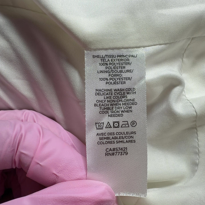 Cream polyester button-up jacket back view showing relaxed fit and functional side pockets