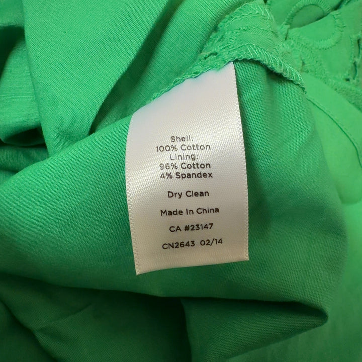 Tag view of green eyelet lace A-line dress showing relaxed fit and midi length