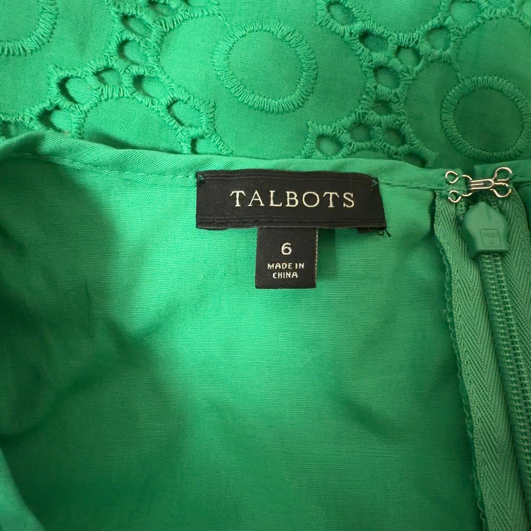 Tag view of green eyelet lace A-line dress showing relaxed fit and midi length