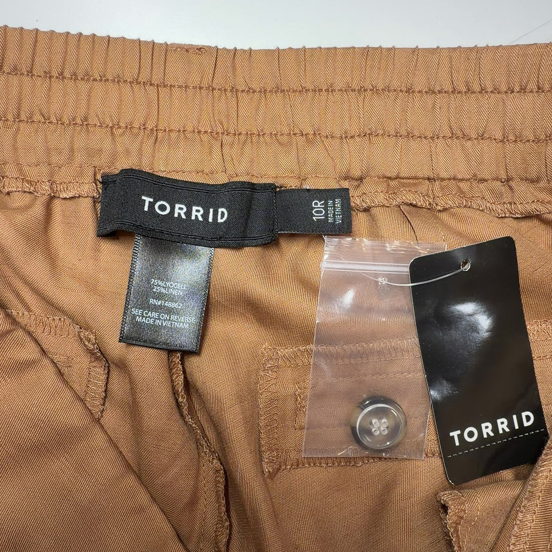 Tag view of camel cargo pants showing cropped ankle length and rear pocket details