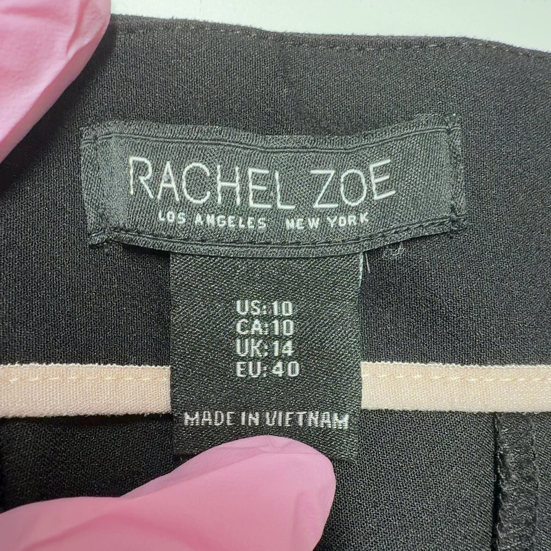 Black flare pants with high-waisted silhouette and stretchy fabric, back view