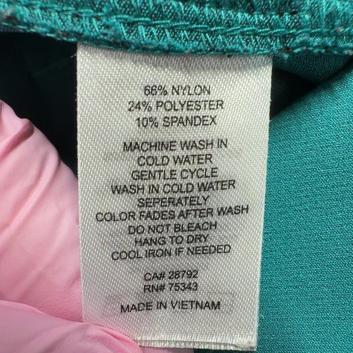 Tag view of teal cropped dress pants showing tailored fit and clean lines