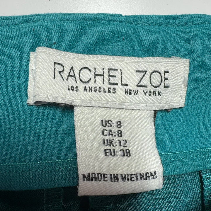 Tag view of teal cropped dress pants showing tailored fit and clean lines