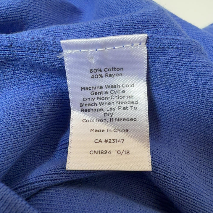 Blue crew neck top with three-quarter sleeves, back view on model
