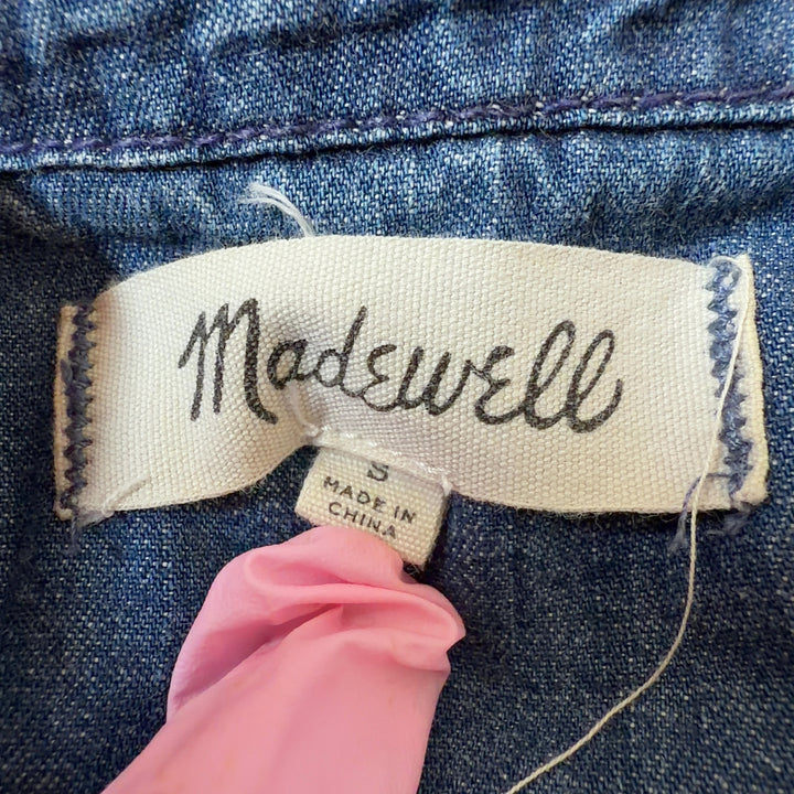 Blue denim cropped top with frayed seam detailing, back view