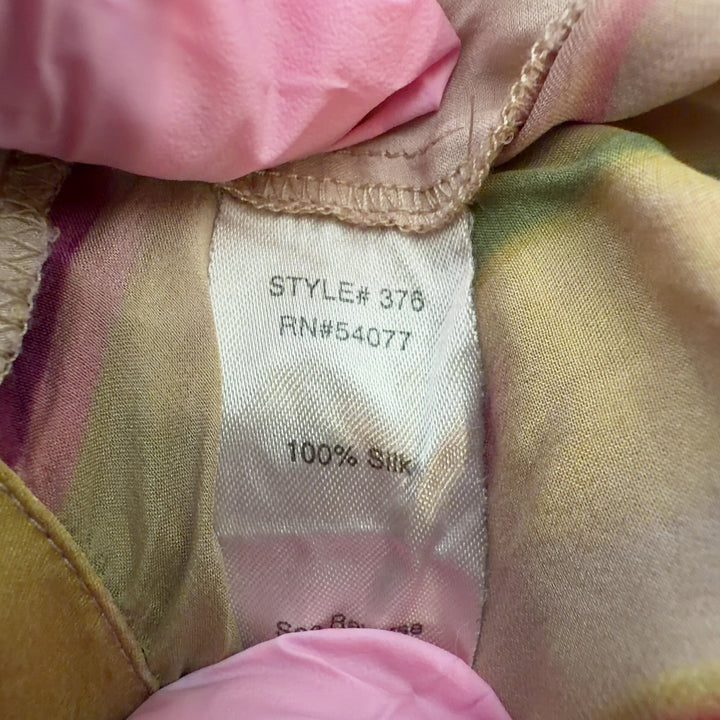 Tag view of multicolor silk ikat print pants showing tapered silhouette and elastic waistband with tie detail