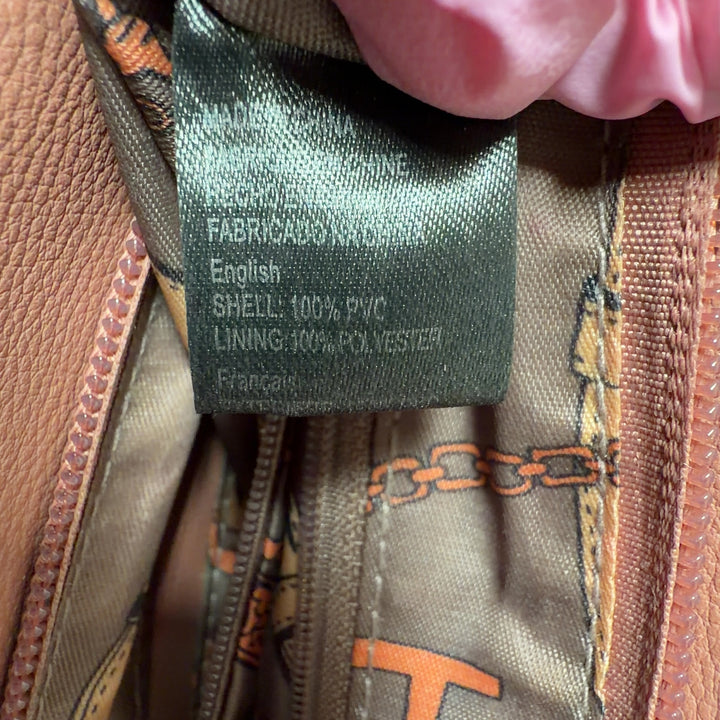 Tag view of tan SilkRoll crossbody bag worn across body showing padlock closure and side zip details