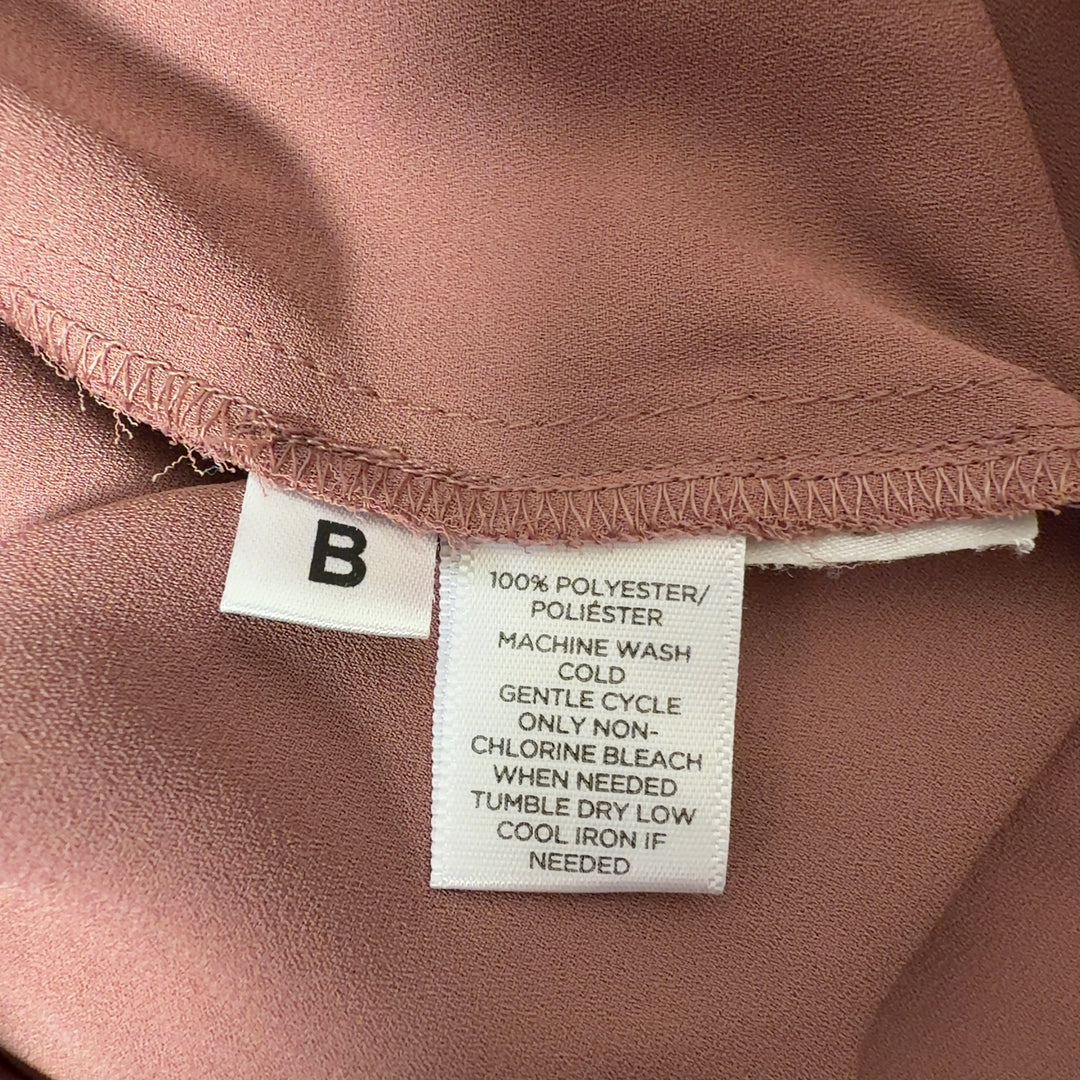 Mauve tie neck button-up blouse with black contrast trim, back view showing tie detail