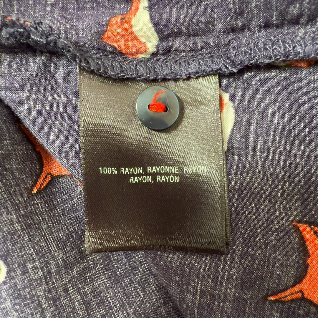 Tag view of navy fox print Maeve top showing pleated bust detail and button closure