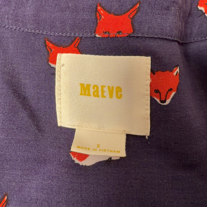 Tag view of navy fox print Maeve top showing pleated bust detail and button closure