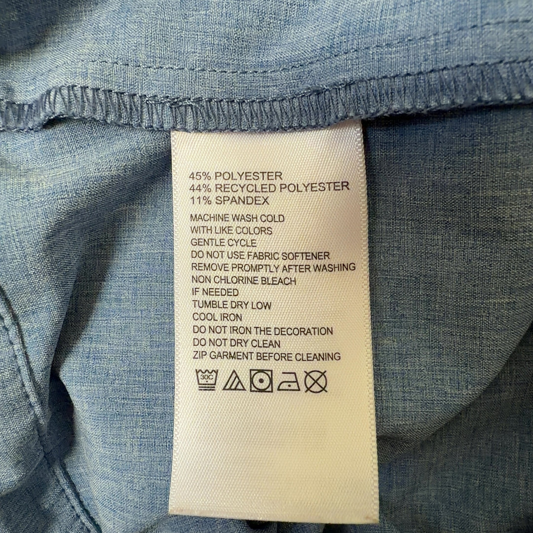 Tag view of light blue denim windbreaker jacket showing drawstring hem details